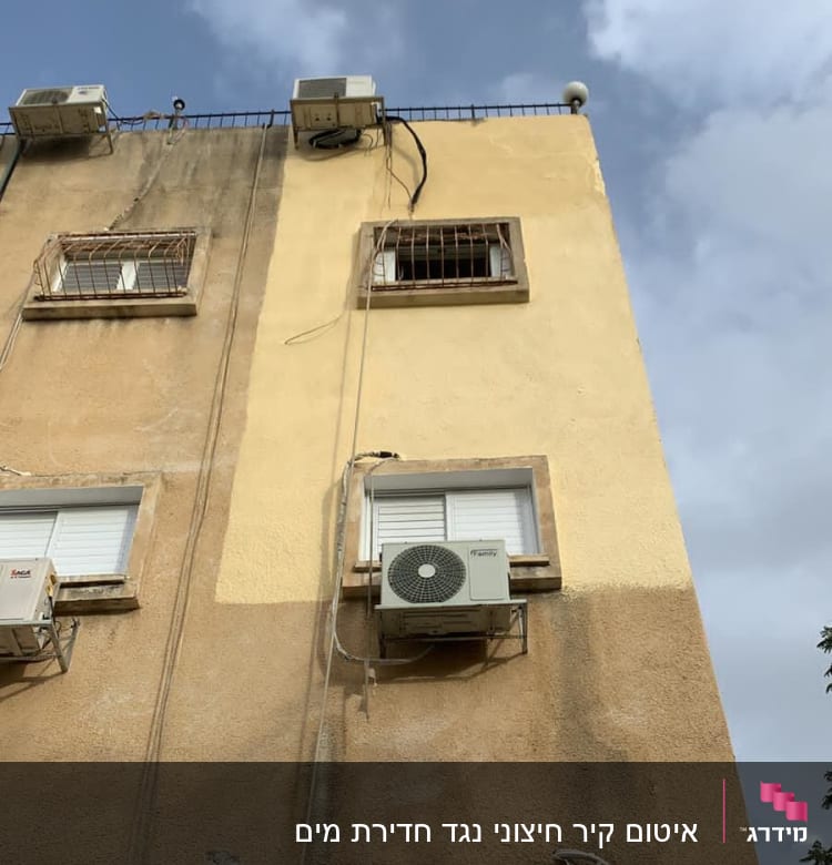 מזגנים מותקנים על קיר בניין עם חוטים חשופים